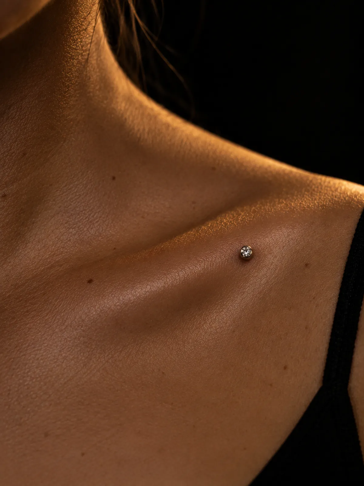 Microdermal serti d'un zircon posé sur une clavicule